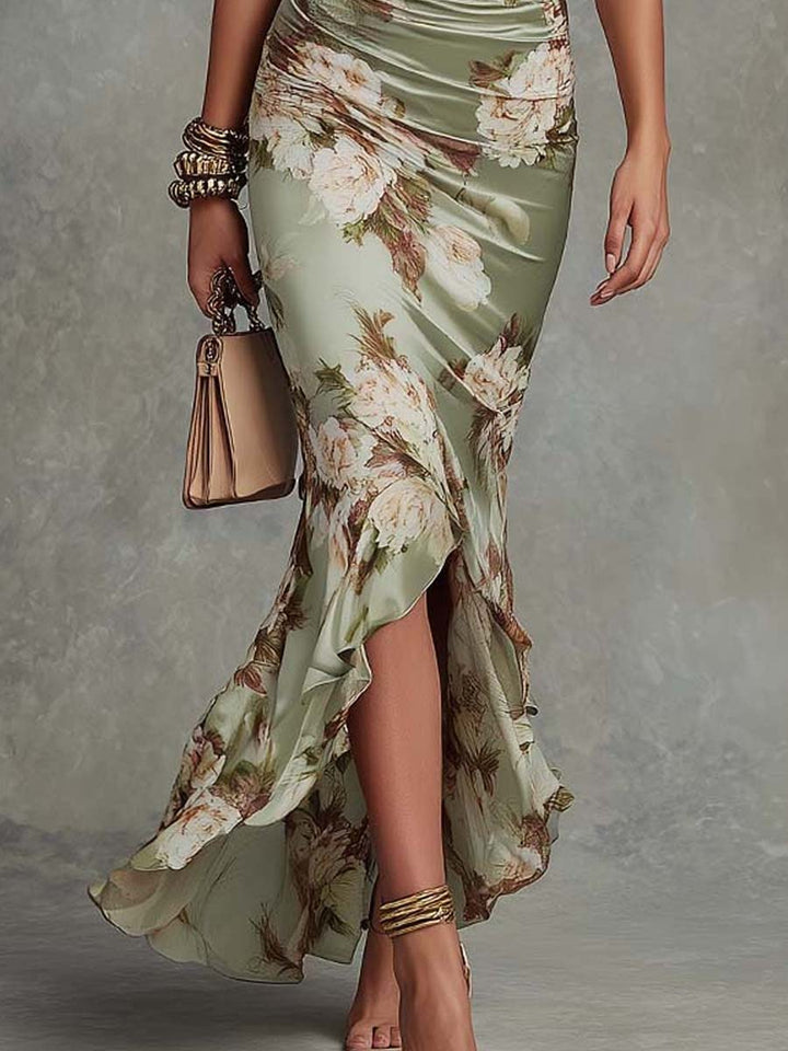 Close-up of the beautiful navy floral pattern on an elegant women's asymmetrical long midi dress, great for parties.