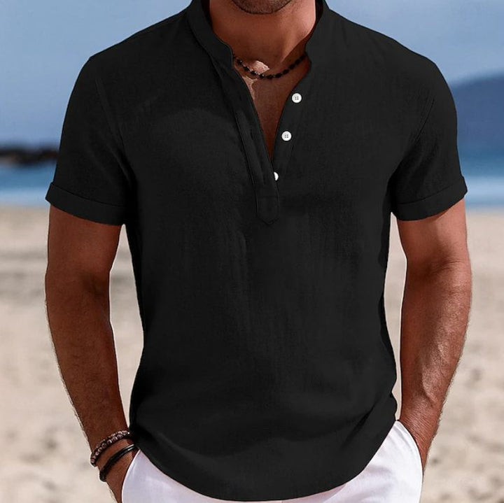 A man wearing a blue casual short sleeve button-front shirt, ideal for summer everyday style.