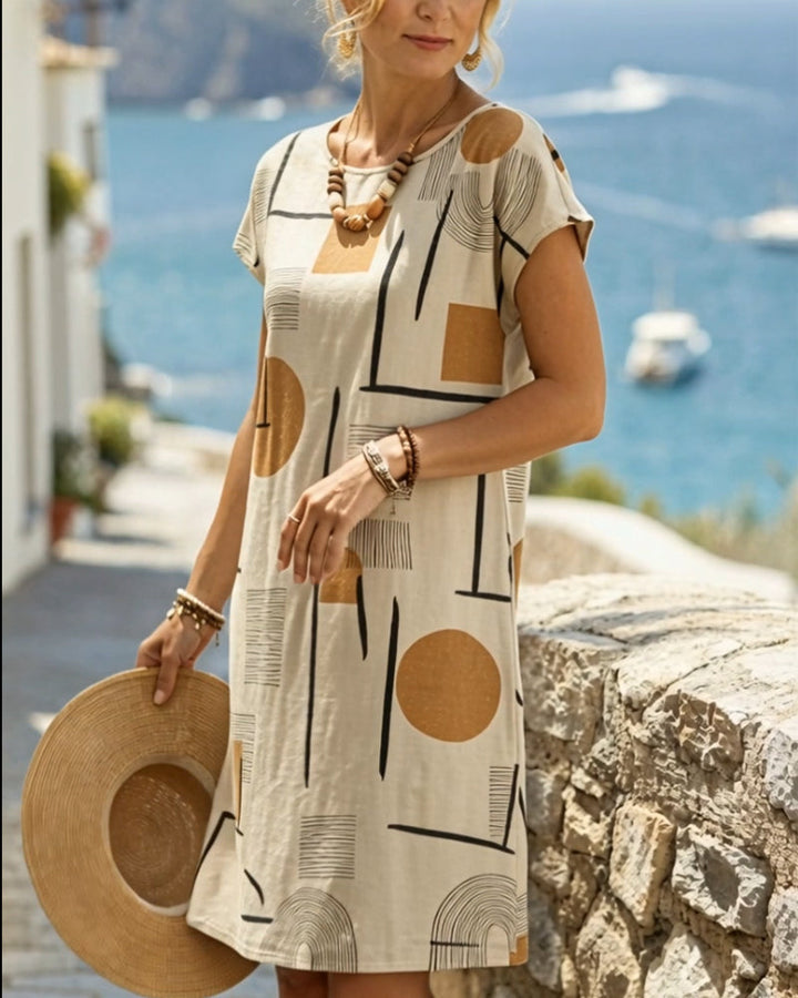 Modern short sleeve mini dress featuring a bold abstract geometric pattern.
