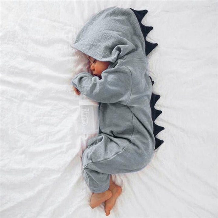 Cute baby dinosaur onesie featuring playful 3D spikes. Soft infant romper, perfect for baby fashion.
