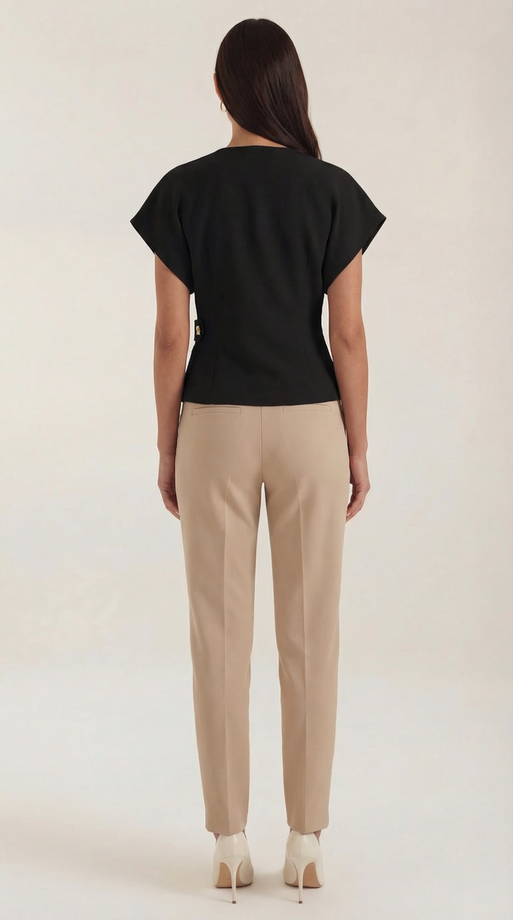 A flat lay of the Amy V-Neck Blouse, emphasizing its v-neck and wrap front for chic style.