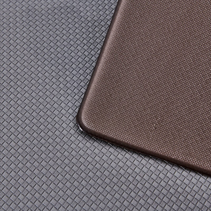 Person enjoying cushioned comfort on an anti-fatigue kitchen rug. Waterproof and anti-slip mat for daily use.