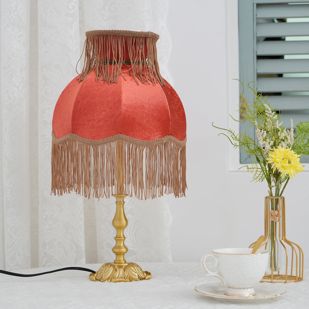 Warm glow Arina red lamp, decorative brass base, ideal accent lighting for tables.