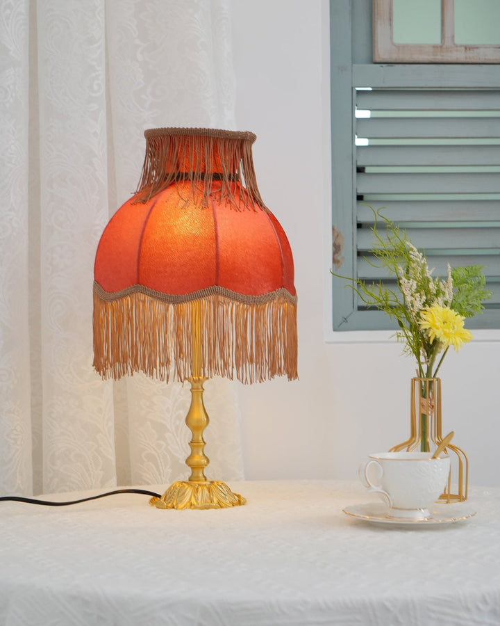 Modern red table lamp, Arina, with bright brass accents, stylish home decor piece.