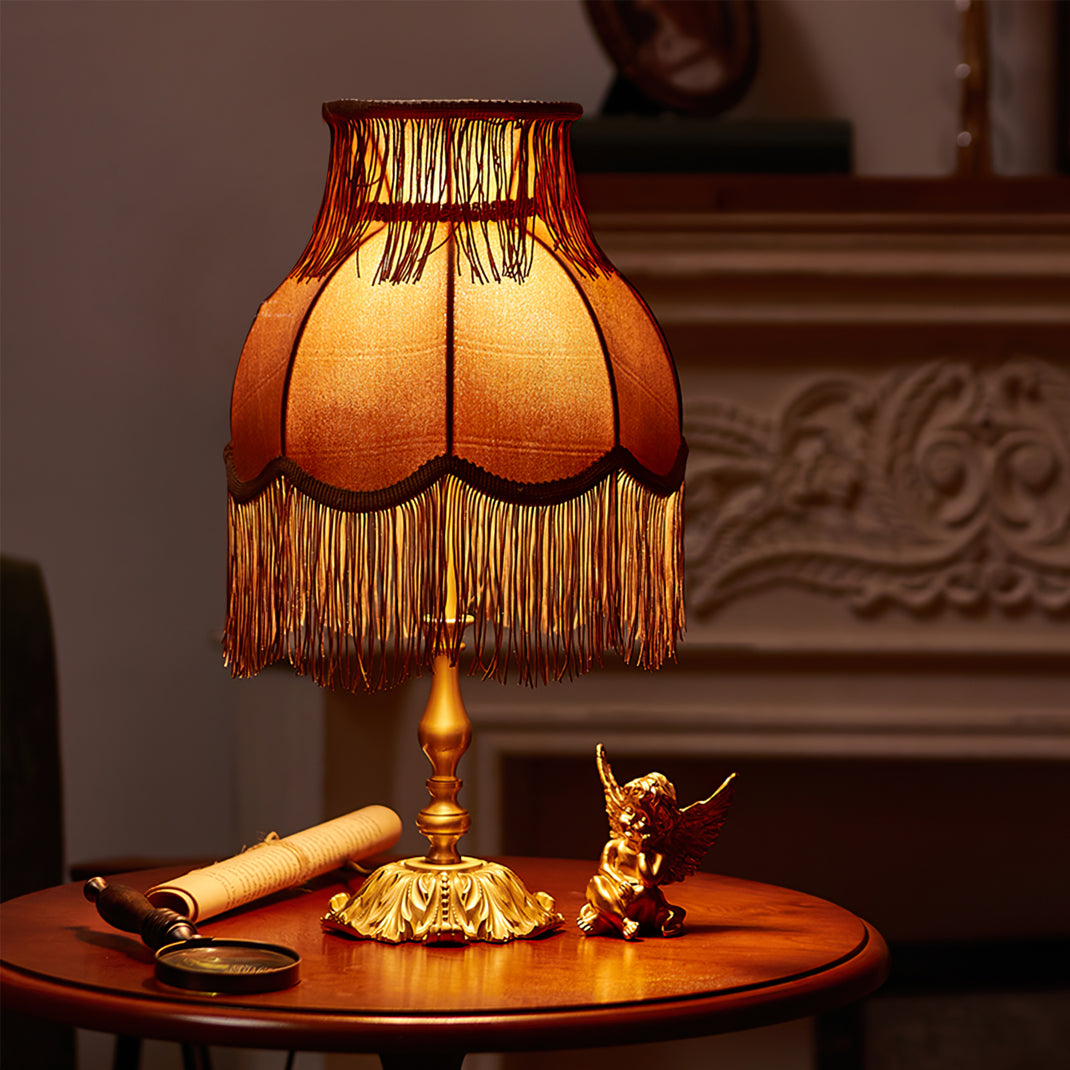 Stylish red lamp, Arina, with a shiny brass stand, provides warm accent illumination.