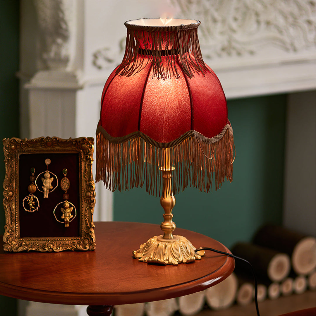 Stylish Arina red table lamp with elegant brass base, perfect for accent lighting.