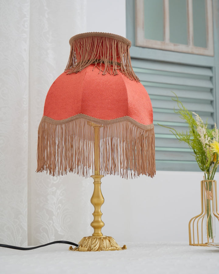 Eclectic Arina red lamp with brass elements, perfect for unique home decor style.