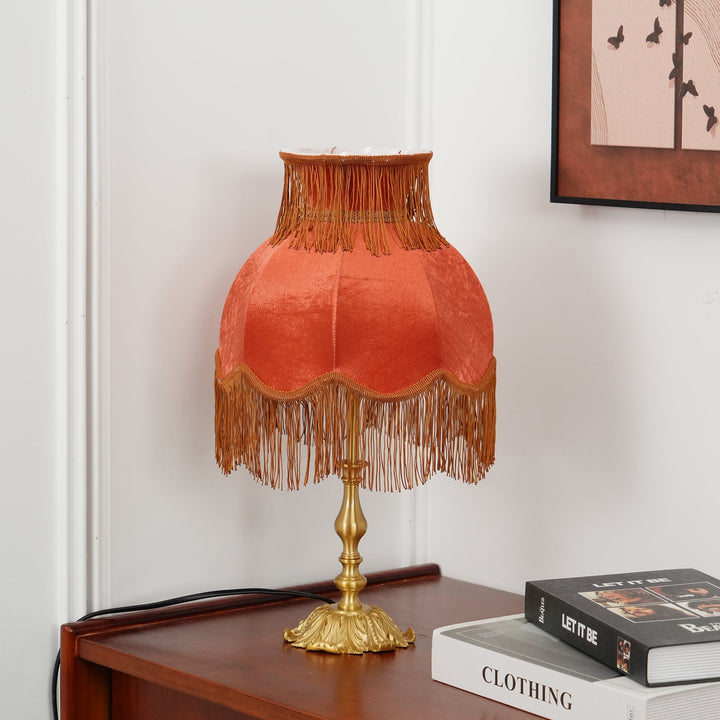 Eclectic Arina red table lamp featuring a sleek brass stand, statement decor.
