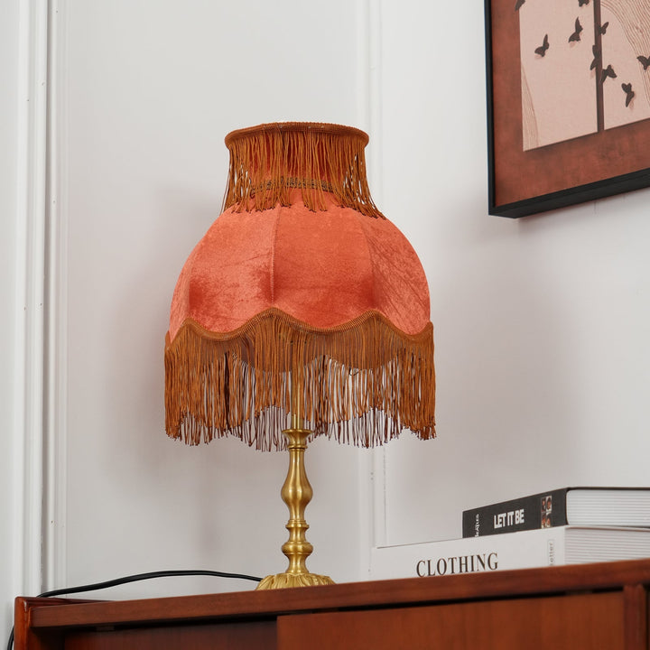 Modern Arina red lamp with brass details, ideal for living room accent lighting.