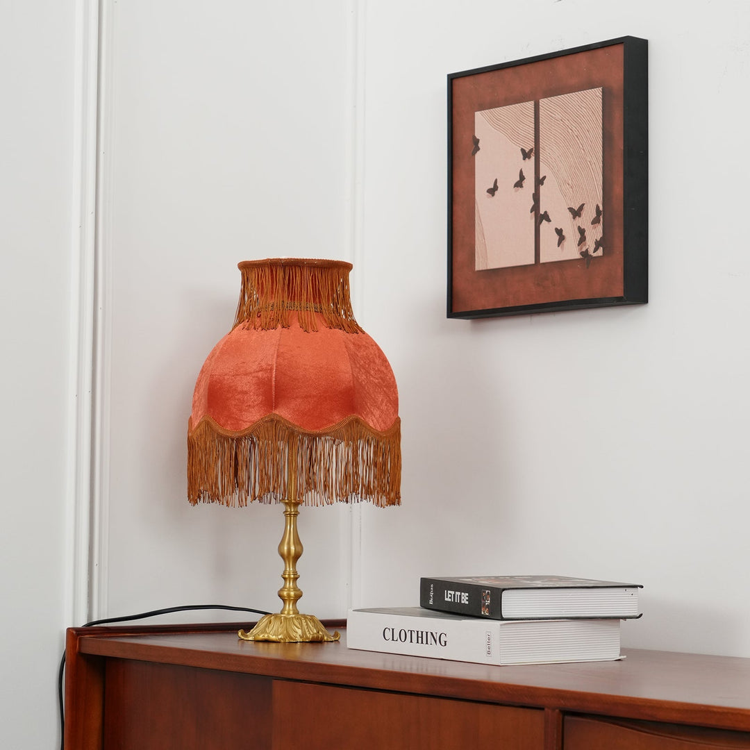 Decorative red table lamp by Arina, with a chic brass base for home decor.