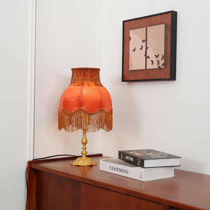 Classic red and brass table lamp, perfect for bohemian or modern interior design.
