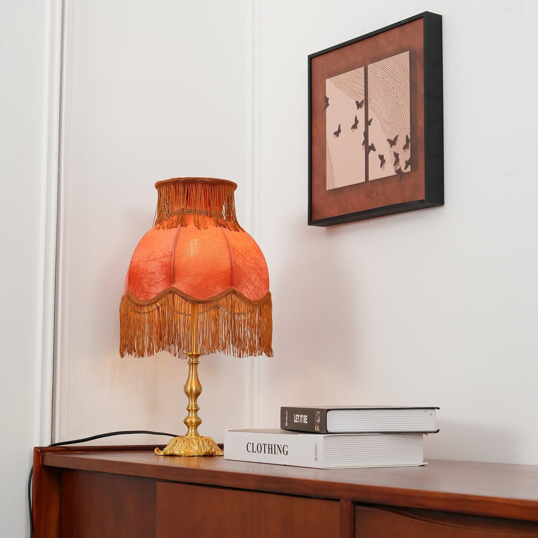 Arina statement lamp: vibrant red shade, polished brass base, accent lighting fixture.