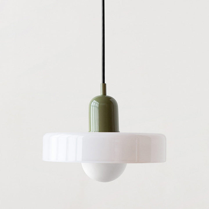 Ambient lighting provided by a Bauhaus-style glass pendant fixture.