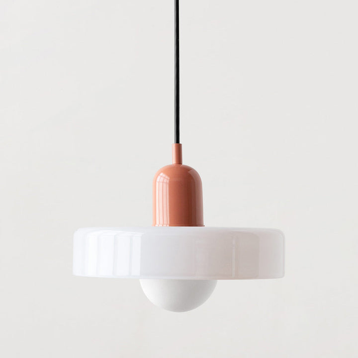 Modern Bauhaus pendant light casting a warm glow in a living room.