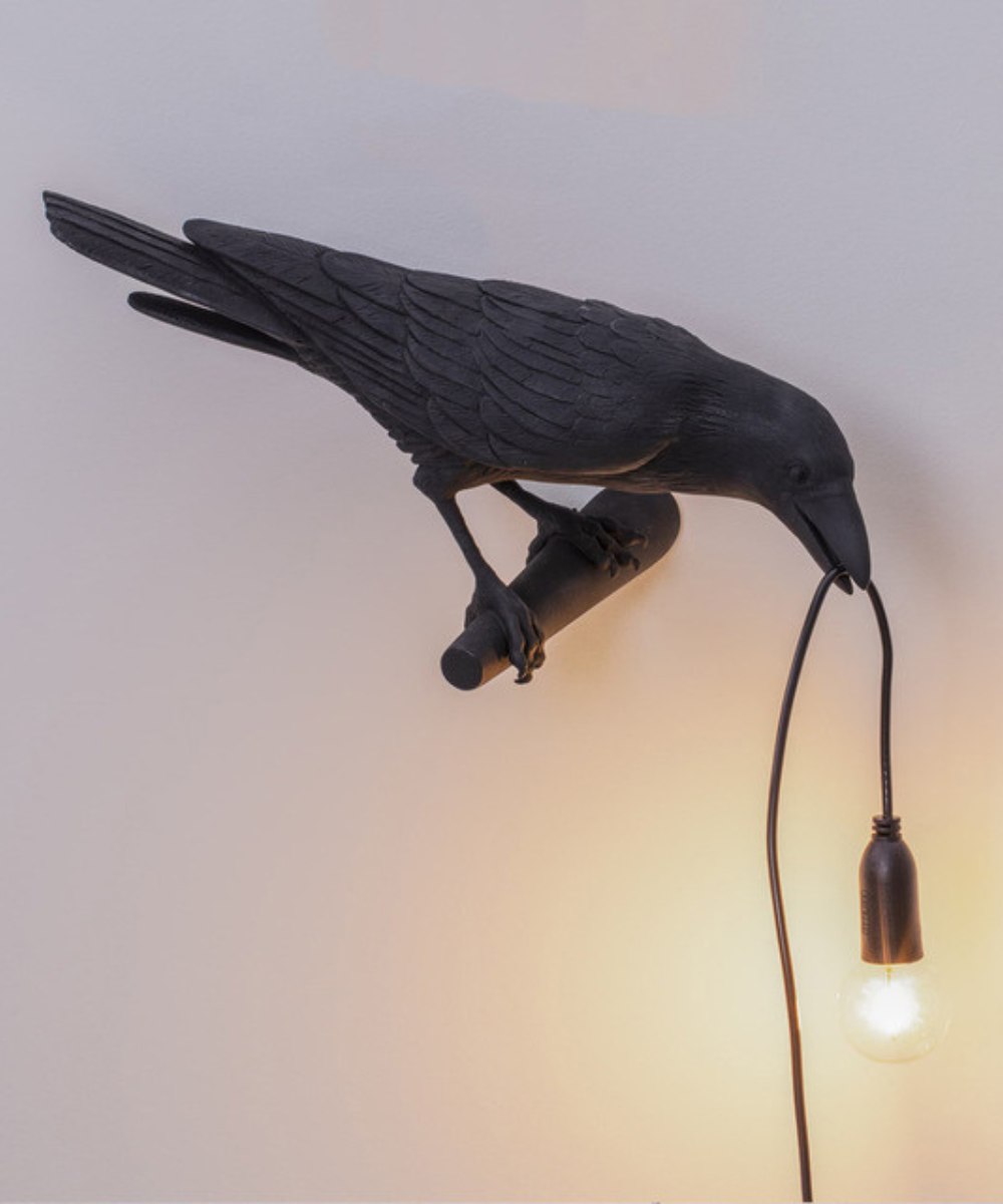 Decorative crow table lamp featuring an artistic bird design, a unique home accent for modern interior styles.