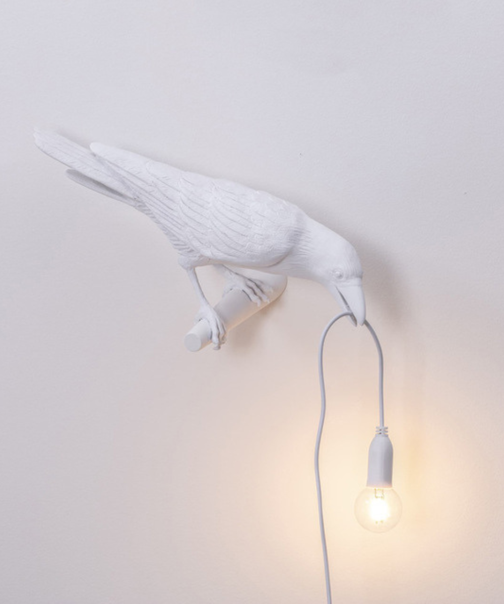 Artistic crow table lamp with a unique bird design. Modern decorative lighting, a distinctive home accent piece.