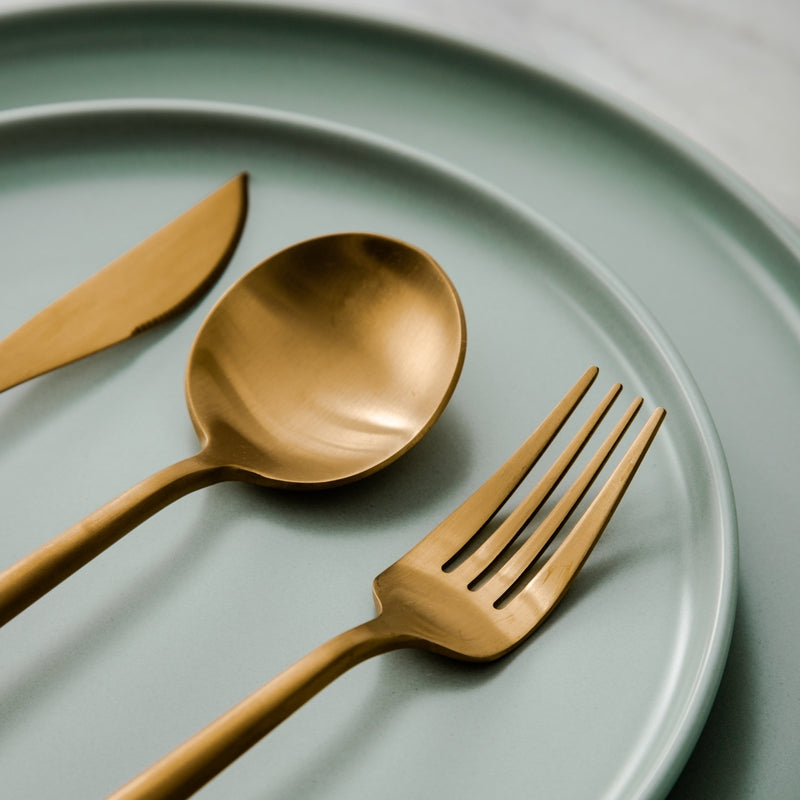 Rose gold Aurora flatware set, minimalist design, enhancing modern home decor.