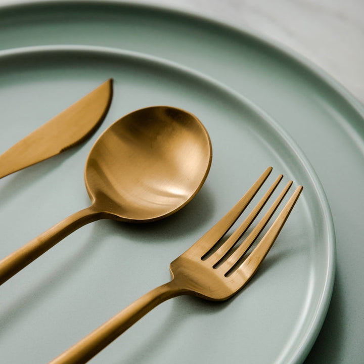 Rose gold Aurora flatware set, minimalist design, enhancing modern home decor.