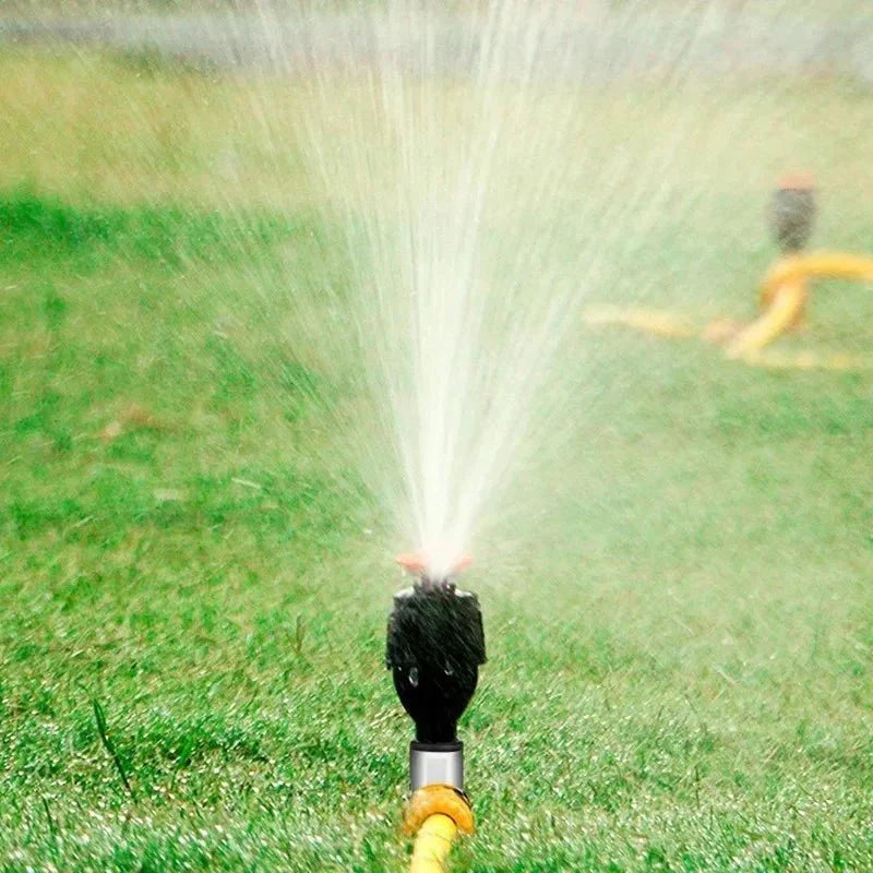 Garden sprinkler in action, providing consistent plant care and lawn hydration.