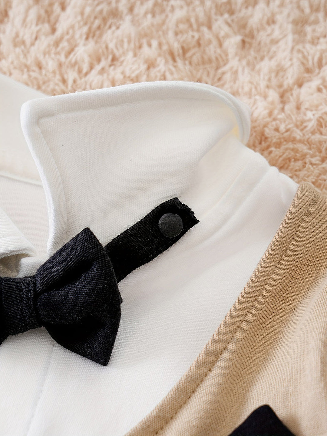 Easy wear baby romper in a gentleman style, complete with a smart bow tie.