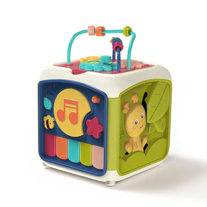 Close-up of a baby exploring shapes on an educational musical activity cube.