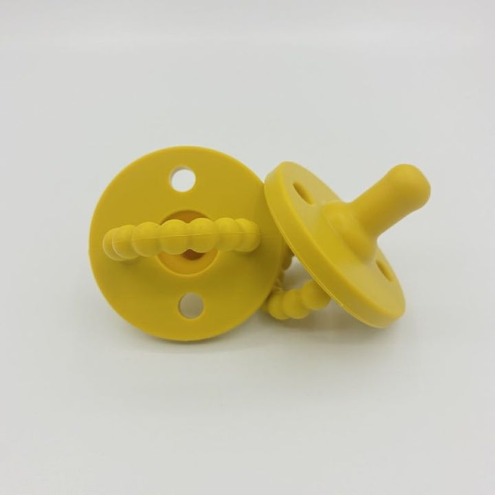 Adorable baby gift set featuring a silicone pacifier and coordinating teether.