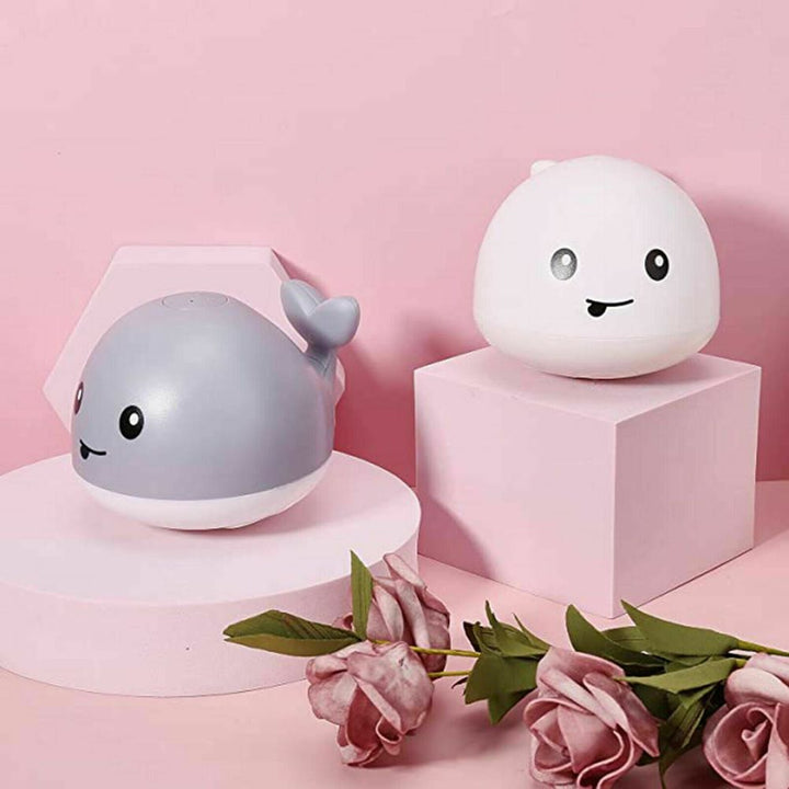 Cute whale LED bath toy that sprays water, an engaging educational toy for infants.