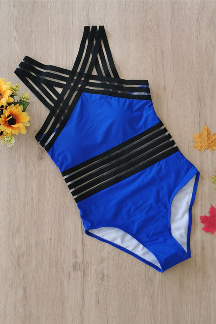 Floral patterned monokini, women's crossed strappy one-piece for vacation.