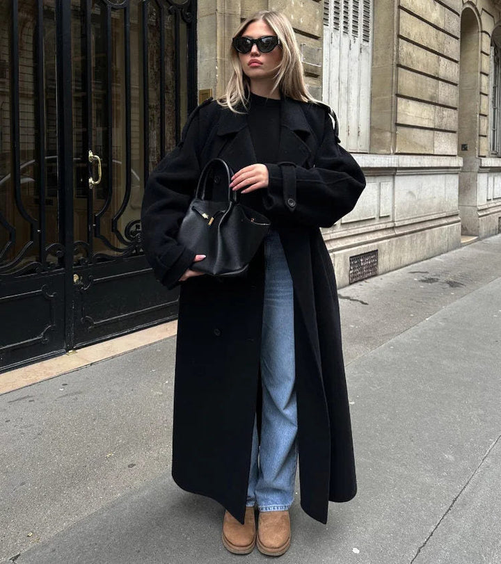 Black women's classic double-breasted trench coat with belt, ideal for sophisticated fall/winter style.