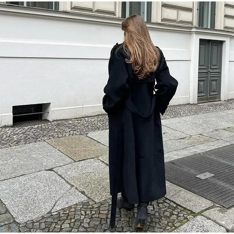 Classic women's belted trench coat. Double-breasted jacket, sophisticated style for everyday or office wear.