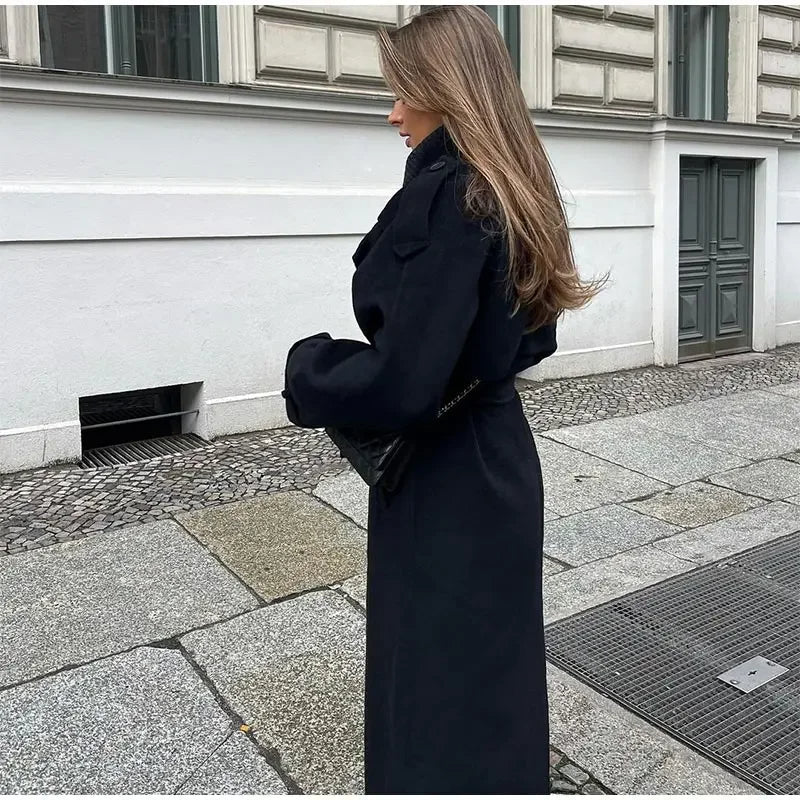 Fashionable women's double-breasted trench coat with stylish belt. A timeless piece of fall/winter outerwear.