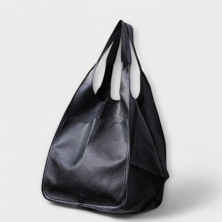 Black women's faux leather tote bag, spacious & stylish for everyday use.