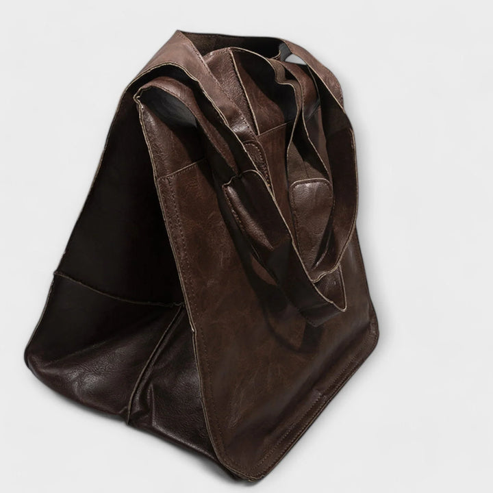 Chic red women's tote bag, faux leather, spacious interior, elegant & practical.