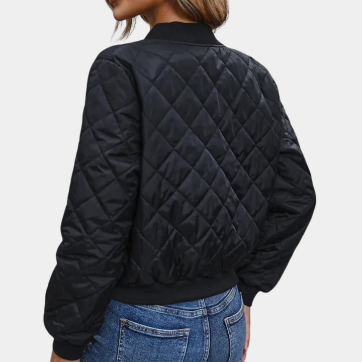 Stylish women's black puffer bomber jacket with full-zip closure & ribbed cuffs. Ideal for fall & winter casual urban fashion.