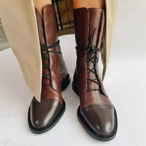 Full view of stylish black women's lace-up ankle boots, showcasing their versatile design.