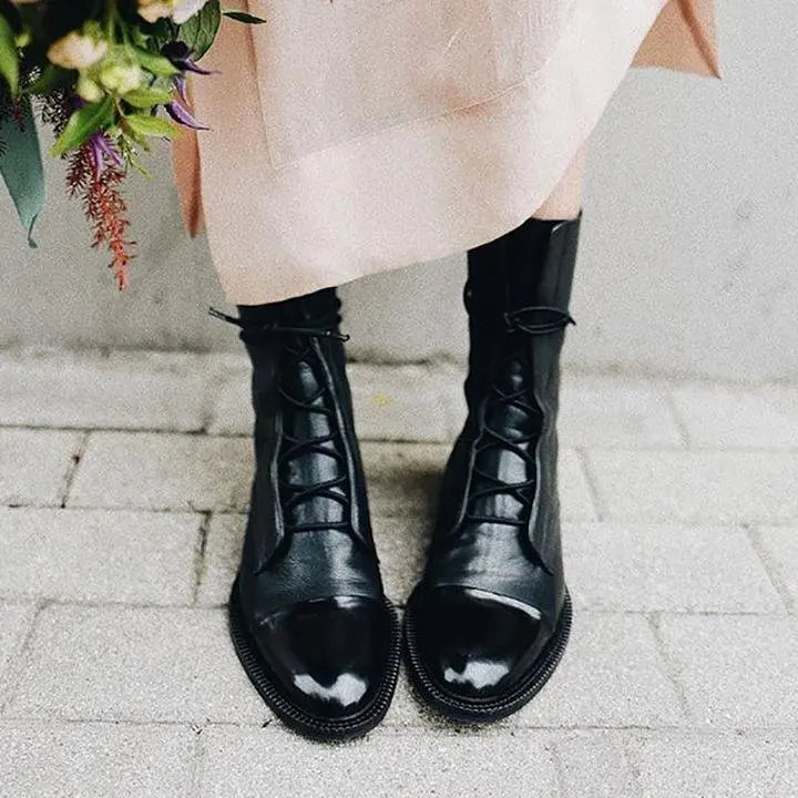 Stylish women's black ankle boots with lace-up detail. Classic design for everyday comfort.