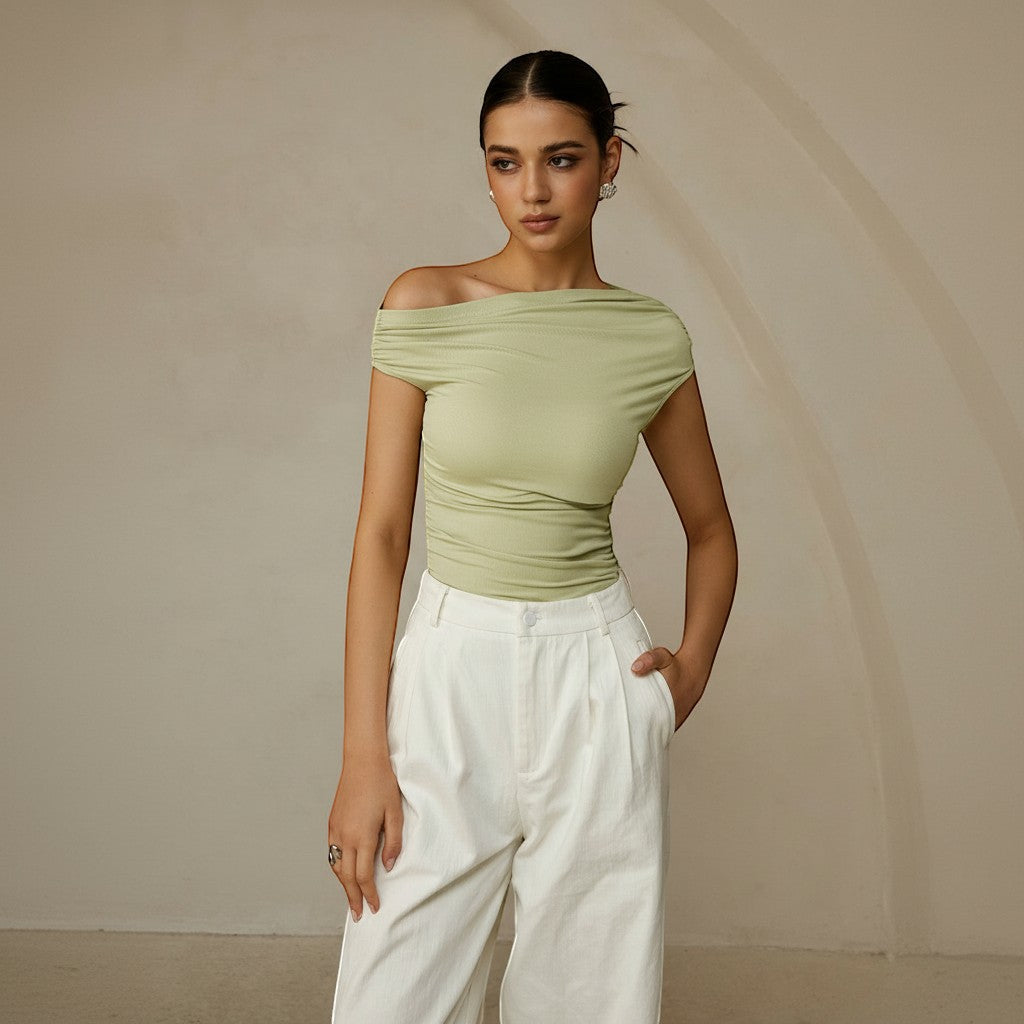 Black women's one shoulder ruched fitted top with an asymmetrical neckline.