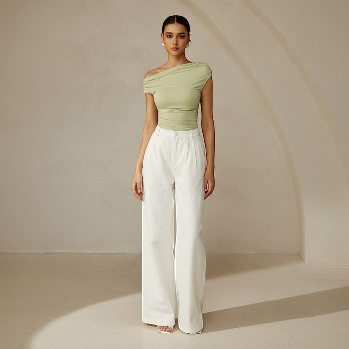 Women's asymmetrical one shoulder top, ruched detailing, fitted for a sleek silhouette.