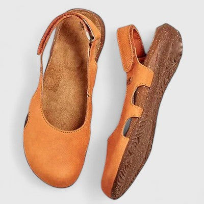 Orange women's comfort walking sandals with arch support, adjustable strap, and anti-slip sole for secure wear.