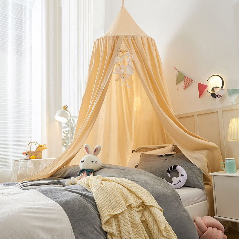 Image of a child happily playing inside the blackout bed canopy, a cozy private space.