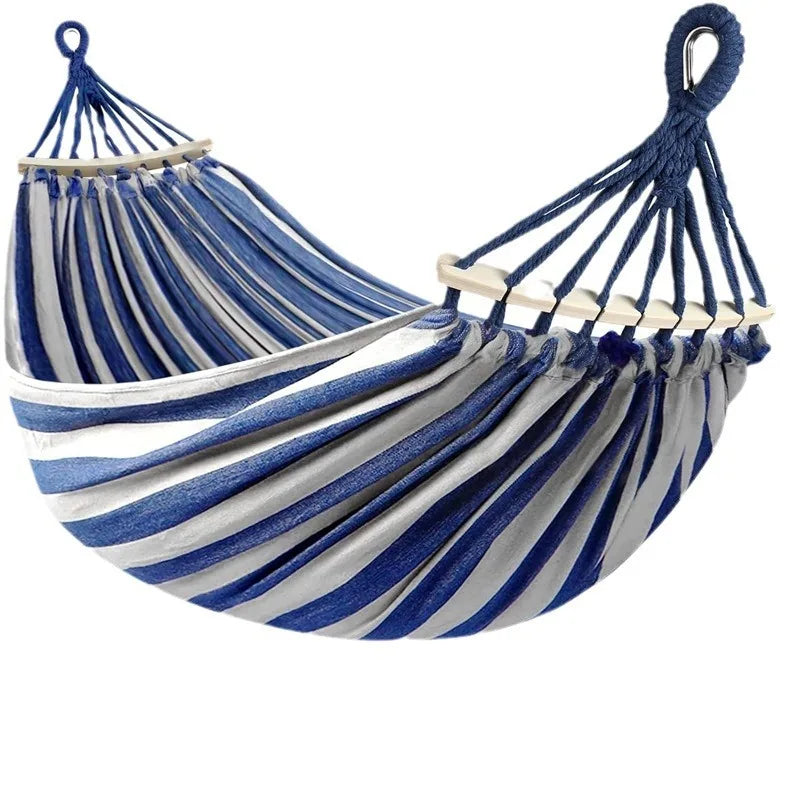 Vibrant blue & red canvas double hammock with sturdy wooden bars, designed for comfortable outdoor relaxation.