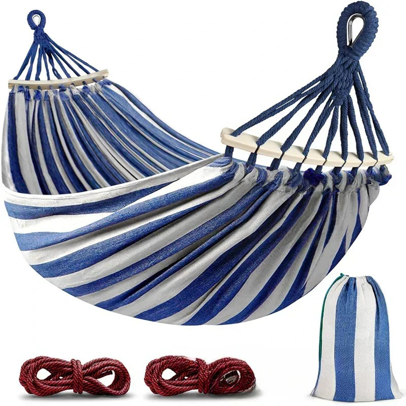 Relax in a high-quality double canvas hammock with wooden spreader bars, perfect for any garden or camping adventure.