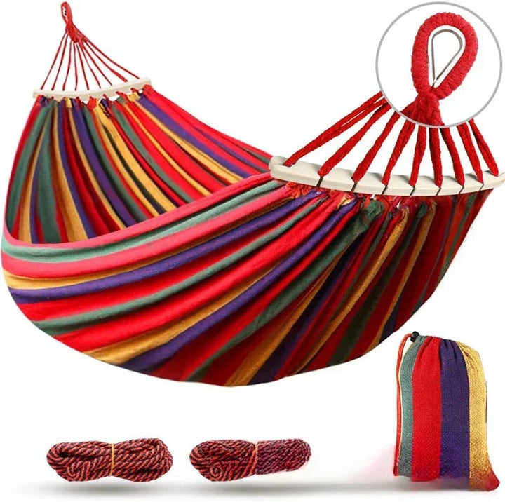 Comfortable double canvas hammock, blue & red design, with strong wooden spreader bars for backyard & patio relaxation.