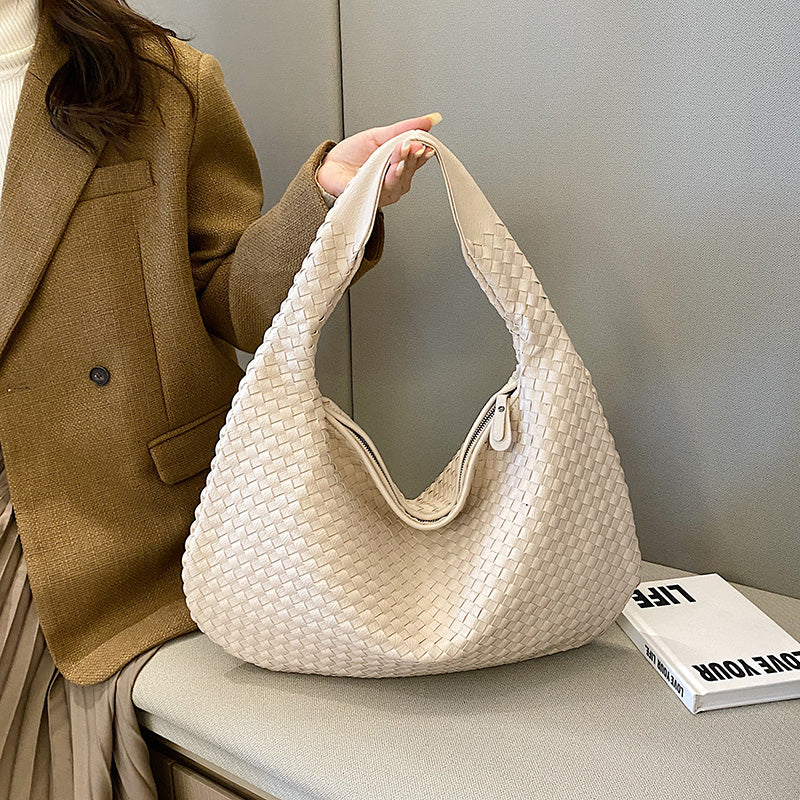 Close-up of chic woven leather handbag showing detailed craftsmanship