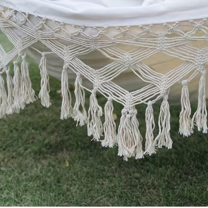 Indoor cozy double hammock, bohemian striped cotton, offering ultimate relaxation.