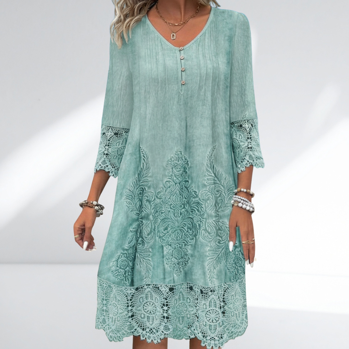 Bohemian embroidered midi dress with intricate floral details and delicate lace trim