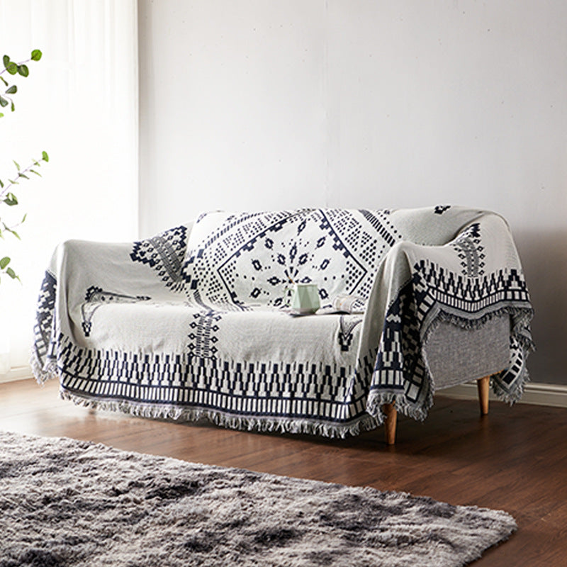 Soft knitted bohemian throw with long tassels, enhancing living room comfort.