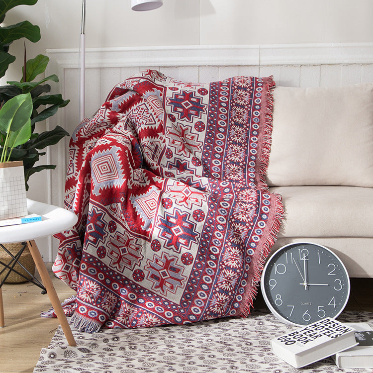 Luxurious bohemian knitted throw blanket with detailed tassels for sofa styling.
