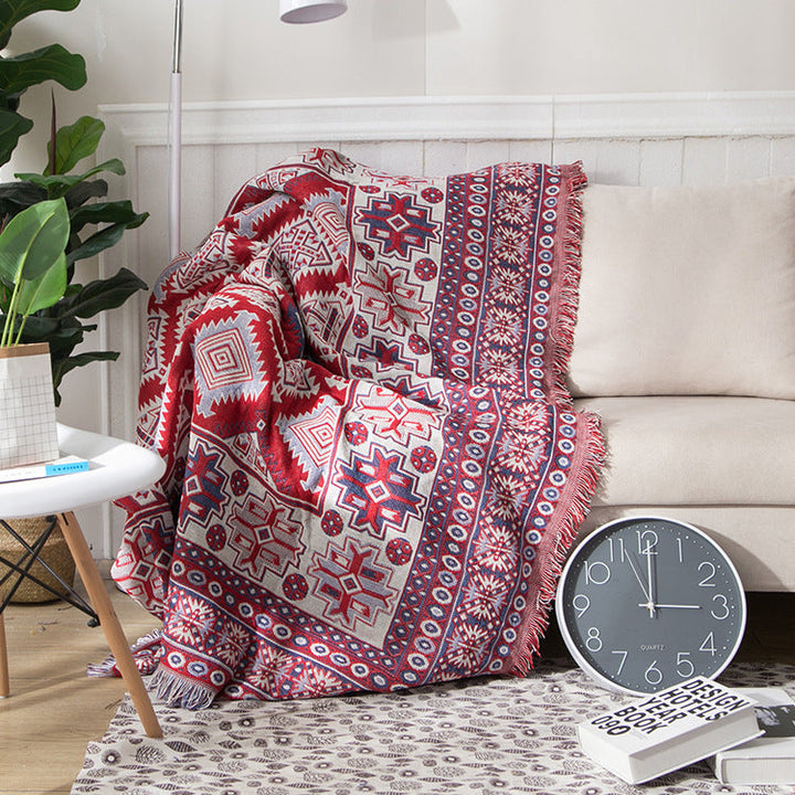 Luxurious bohemian knitted throw blanket with detailed tassels for sofa styling.