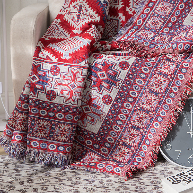 Earthy bohemian knitted blanket with tassels, a warm & inviting sofa throw.